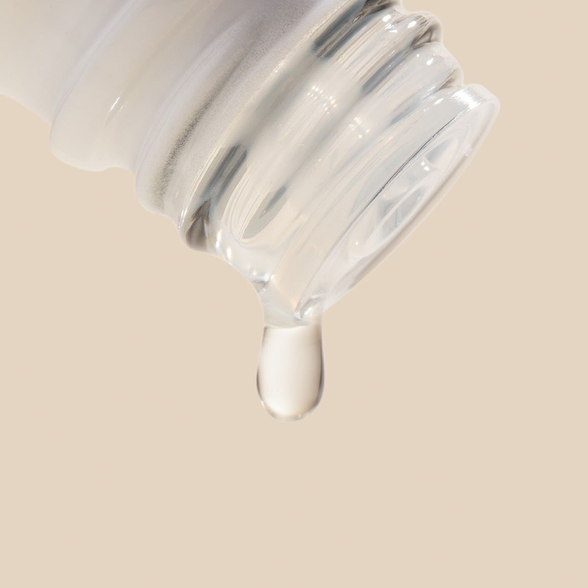Essential oil bottle shown pouring a single drop in close-up