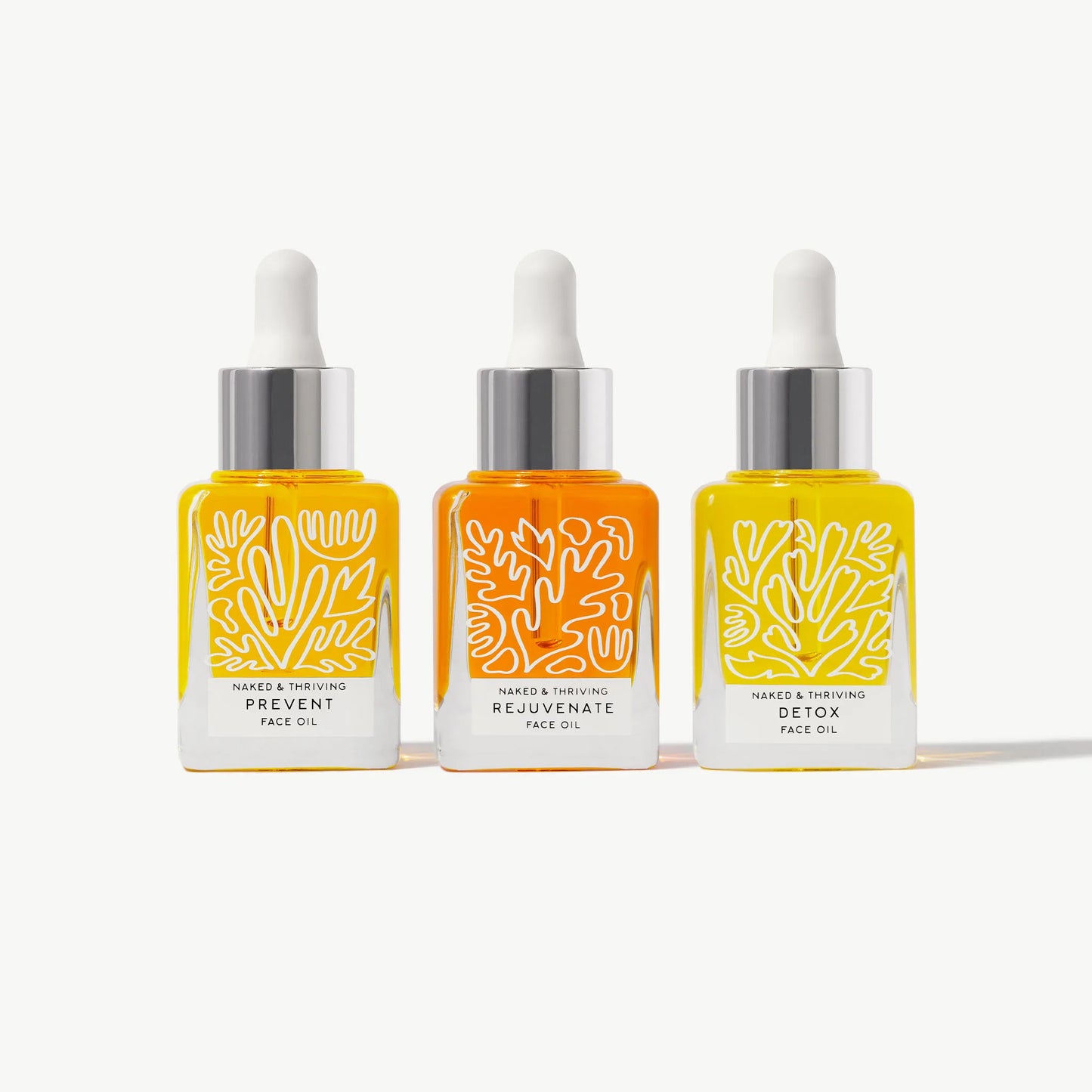 Rejuvenate, Renew, and Detox facial oil bottles arranged together on a white background