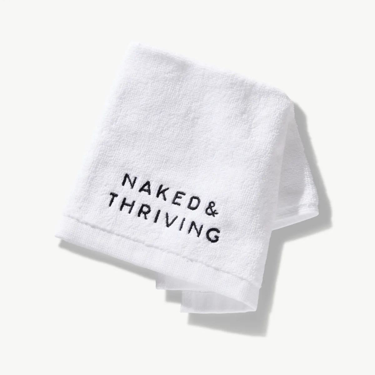 White cotton spa face cloth with Naked & Thriving logo embroidery