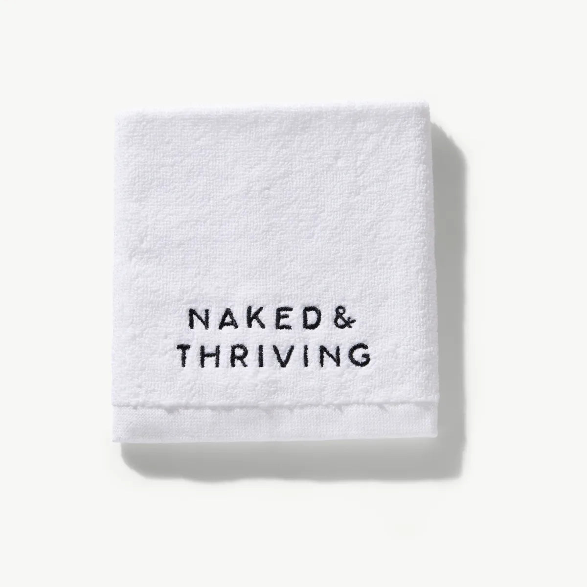 White cotton spa face cloth with Naked & Thriving logo embroidery