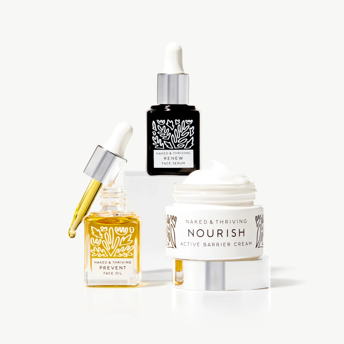 
                
                  Three Naked & Thriving products arranged together, including face oil, serum, and cream.
                
              