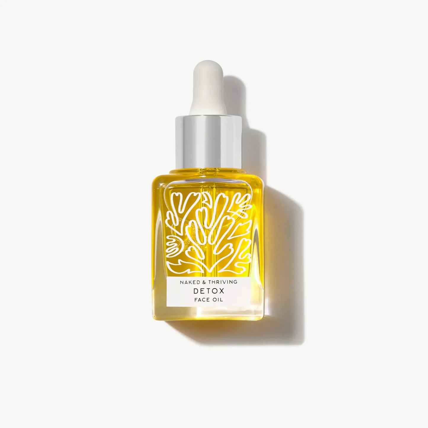 Detox Face Oil in glass dropper bottle on white background