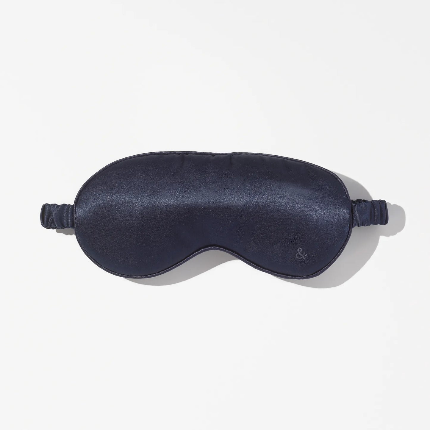 Dark blue sleep mask with smooth finish and band on white background