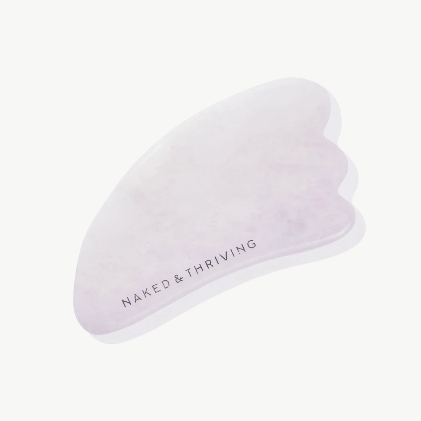 Polished pink gua sha stone engraved with brand name