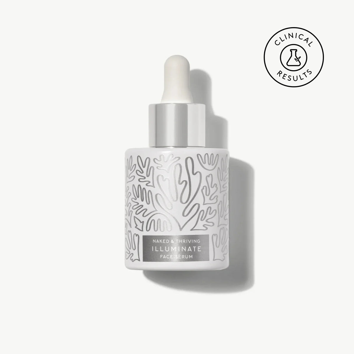 Naked & Thriving Illuminate BC+ Brightening Serum in white glass dropper bottle with light botanical pattern