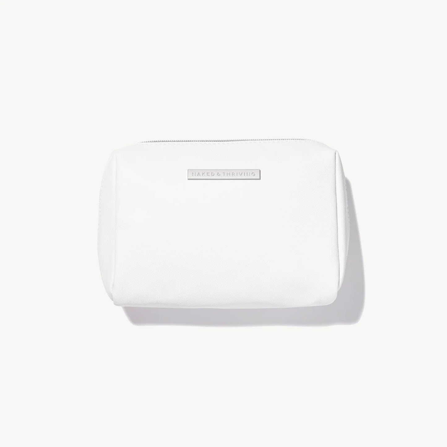 Compact white cosmetic pouch on neutral background