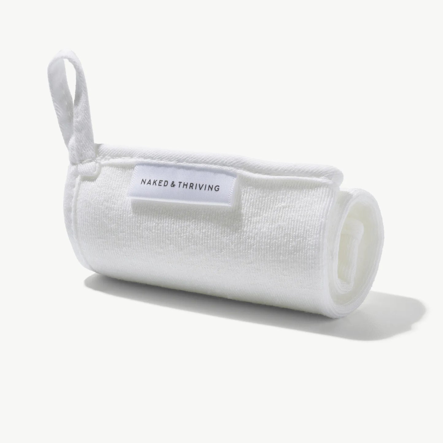 White polishing face cloth rolled and tied, shown on a light background.