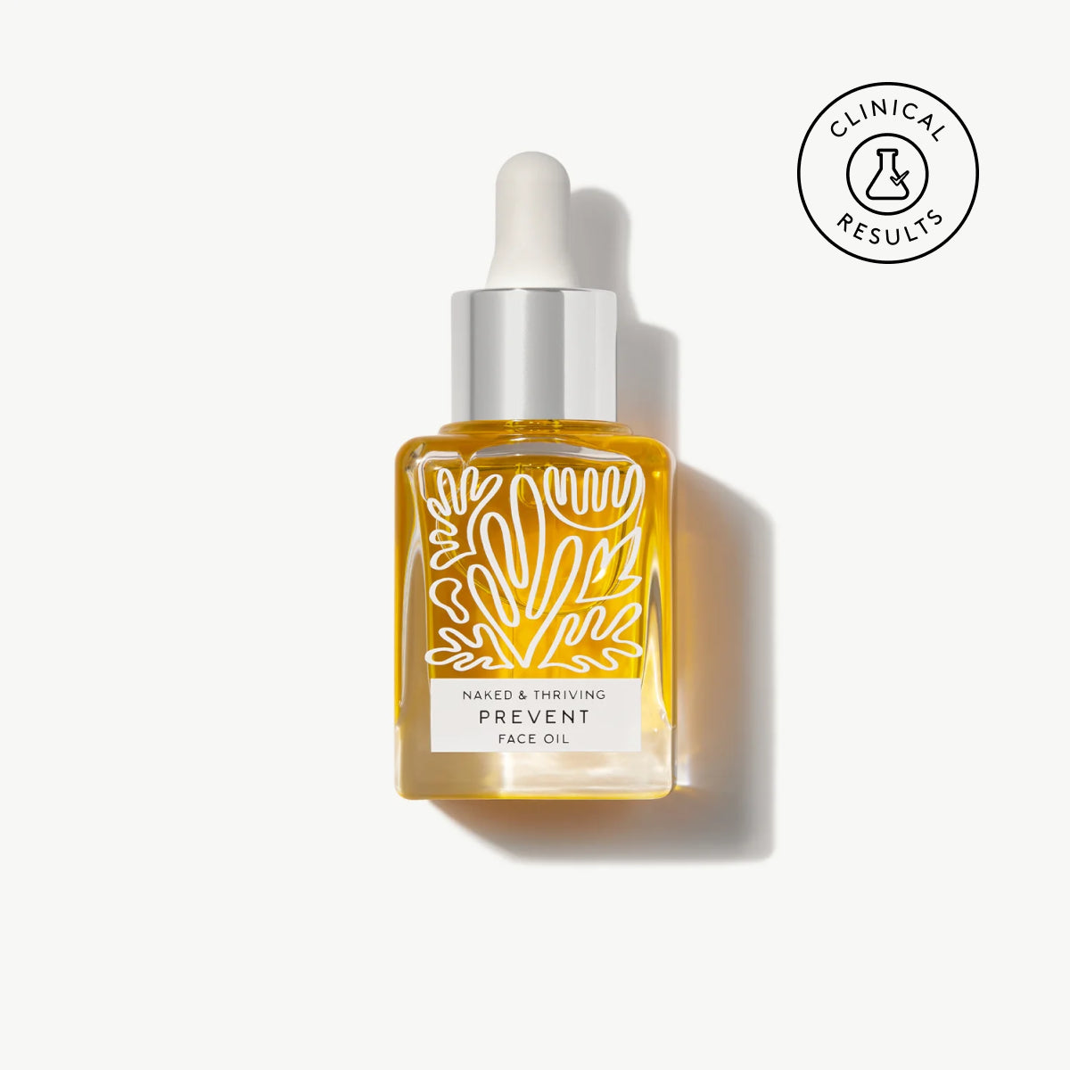 Naked & Thriving Prevent Anti-Aging Face Oil in a clear, botanical-patterned glass dropper bottle