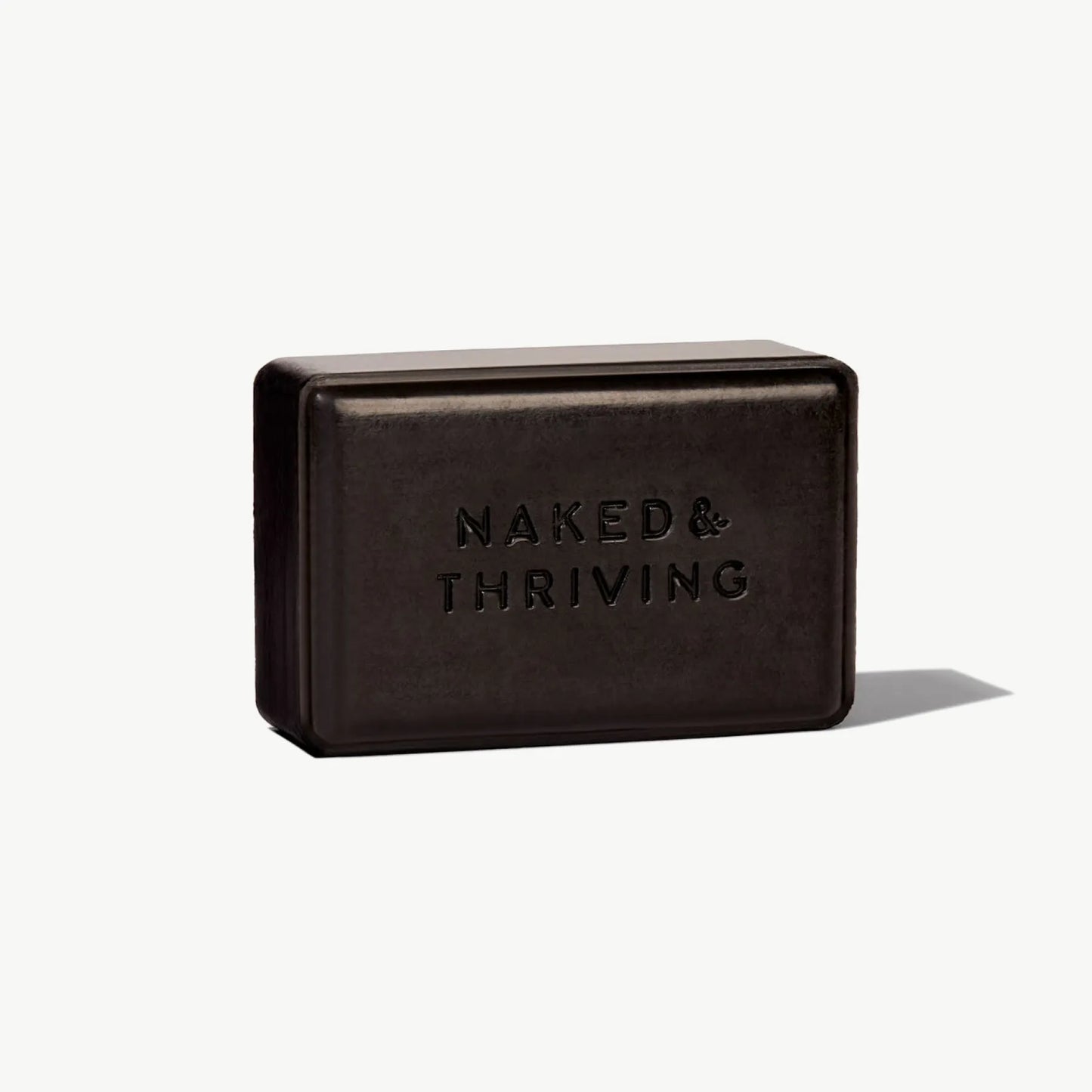 Black Purify Charcoal Cleansing Bar by Naked & Thriving displayed on white background
