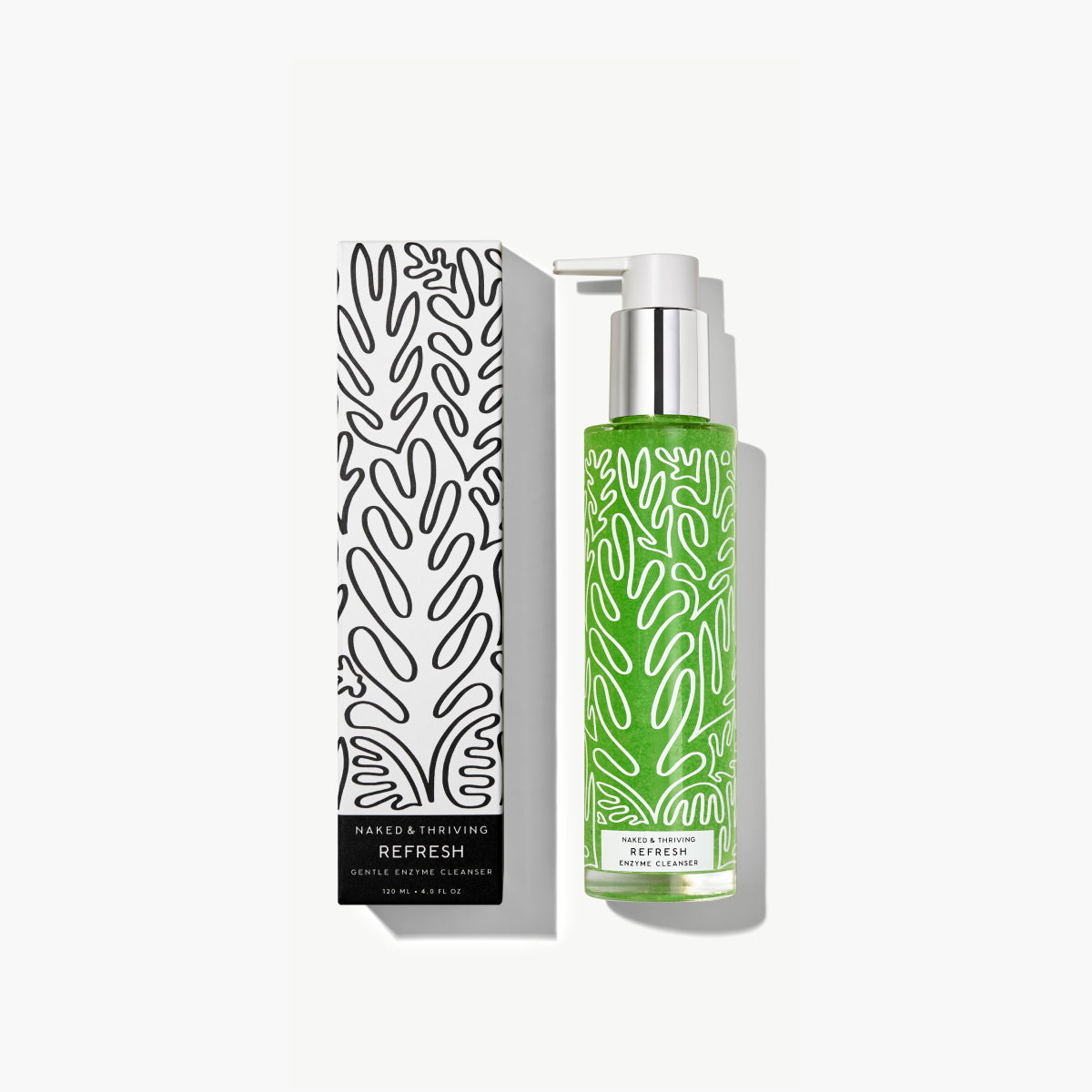 Naked & Thriving Refresh Gentle Enzyme Cleanser showing green formula in a clear pump bottle beside black and white, botanical-patterned box