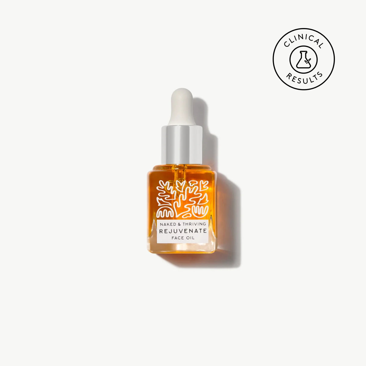 Naked & Thriving travel-size Rejuvenate Restorative Face Oil in botanical-patterned glass dropper bottle