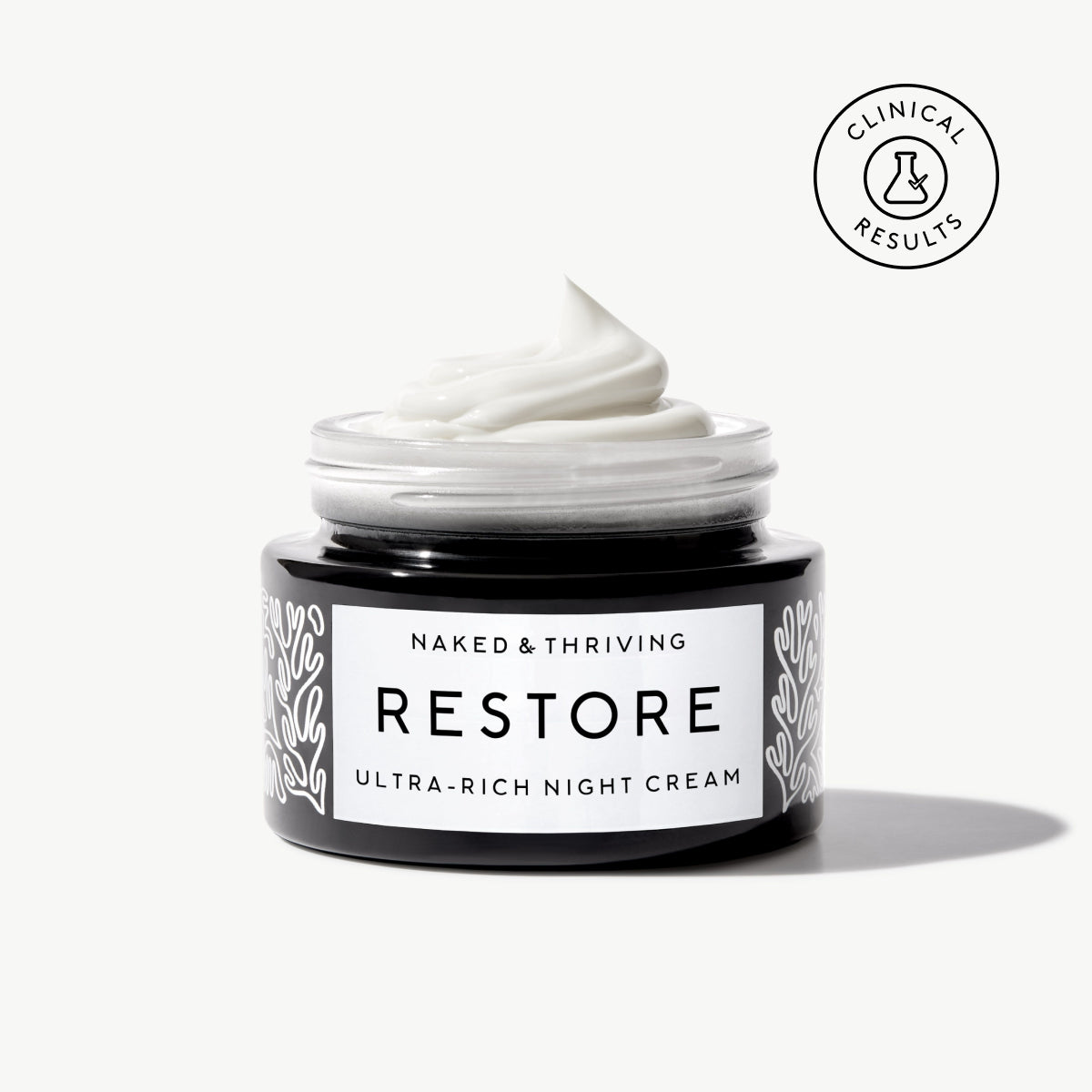 Naked & Thriving Restore Ultra-Rich Night Cream in a black glass jar with brand label