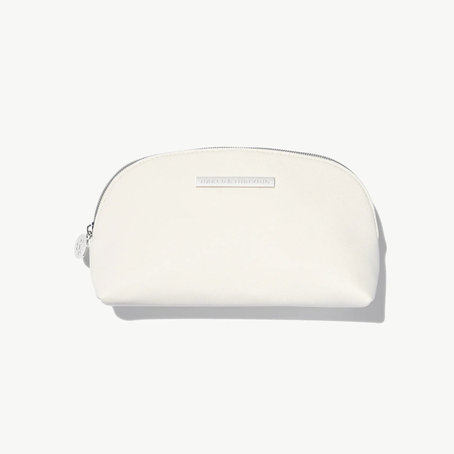 White zip cosmetic pouch photographed on white background