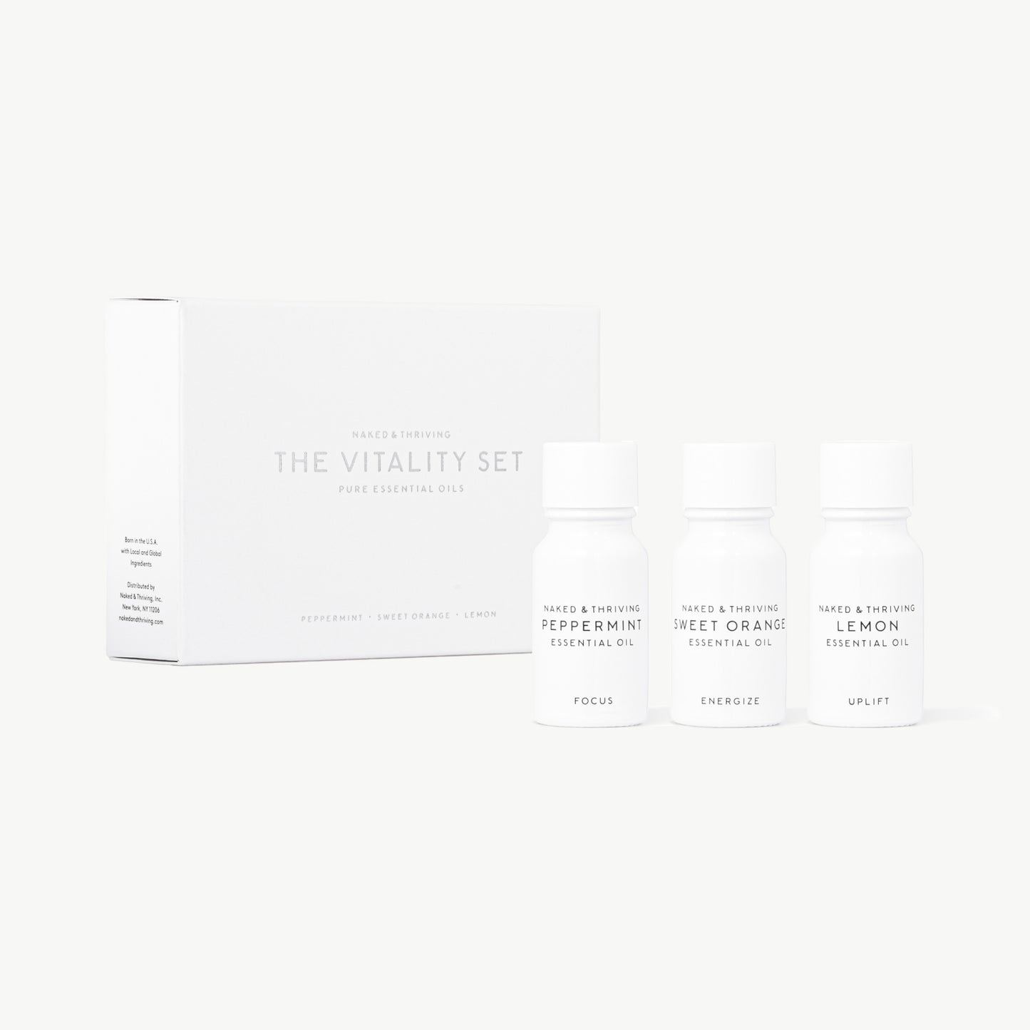 Vitality Set with white Sweet Orange, Peppermint, and Lemon Essential Oils on white background.