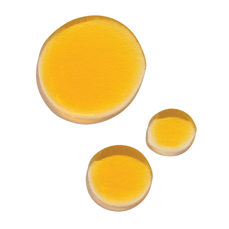 Three golden oil droplets displayed on a white background