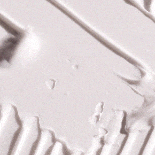 Close-up of white cream texture with smooth ridges